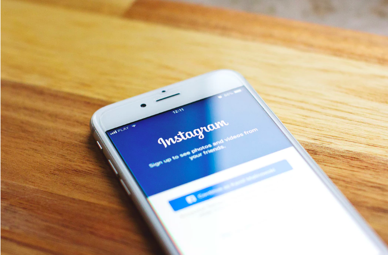 iPhone with the screen showing Instagram login page. 