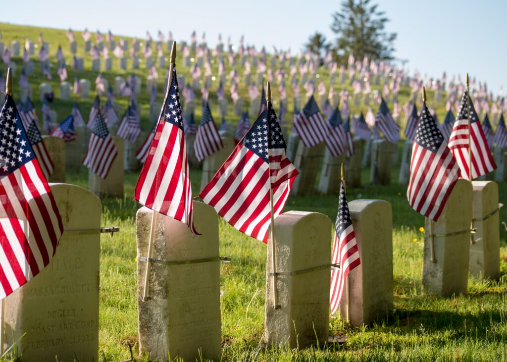 american flags on tombstone for memorial day