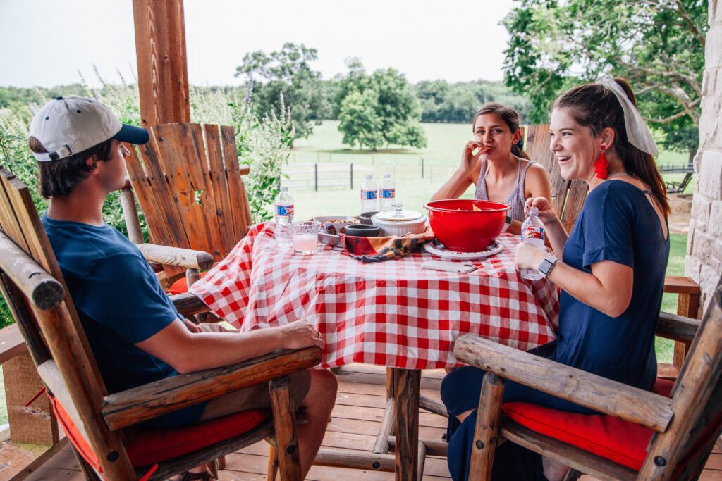 4th of july barbecue. people sitting around a table with a checkered table cloth